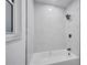 Clean bathroom featuring marble-tiled shower and bathtub at 1414 Vonderay Rd, Orlando, FL 32825