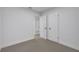Simple bedroom with grey flooring and white walls. Offers double door closet at 1414 Vonderay Rd, Orlando, FL 32825