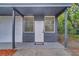 Front entrance with covered porch and grey siding at 1414 Vonderay Rd, Orlando, FL 32825
