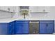 Modern kitchen with blue cabinets, white countertops, and a stainless steel dishwasher at 1414 Vonderay Rd, Orlando, FL 32825