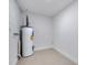 Laundry room with water heater and light grey flooring at 1414 Vonderay Rd, Orlando, FL 32825