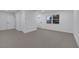 Open living room with gray flooring and a view of the kitchen at 1414 Vonderay Rd, Orlando, FL 32825