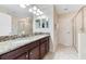 Double vanity bathroom with granite countertops at 1455 Rolling Fairway Dr, Davenport, FL 33896