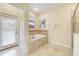 Relaxing bathroom with a large garden tub, separate shower, and private access at 1455 Rolling Fairway Dr, Davenport, FL 33896