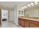 Double vanity with granite countertop and large mirror at 1455 Rolling Fairway Dr, Davenport, FL 33896