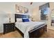 King-size bed, nightstands, and large window in a well-lit bedroom at 1455 Rolling Fairway Dr, Davenport, FL 33896