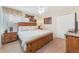King-size bed, wooden frame and neutral color scheme at 1455 Rolling Fairway Dr, Davenport, FL 33896