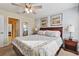 King-size bed and ensuite bathroom in a bright and airy bedroom at 1455 Rolling Fairway Dr, Davenport, FL 33896