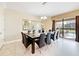 Spacious dining area with seating for 10, large windows and backyard access at 1455 Rolling Fairway Dr, Davenport, FL 33896