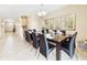 Elegant dining room with a large table, seating for ten, and modern chandelier at 1455 Rolling Fairway Dr, Davenport, FL 33896