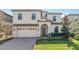 Two-story house with a three-car garage and landscaped lawn at 1455 Rolling Fairway Dr, Davenport, FL 33896