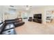 Spacious living area with leather sectional sofa and large TV at 1455 Rolling Fairway Dr, Davenport, FL 33896