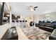 Open living area showcasing a large TV, comfortable seating, and kitchen views at 1455 Rolling Fairway Dr, Davenport, FL 33896