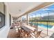 Screened patio with pool, table, chairs, and lounge chairs at 1455 Rolling Fairway Dr, Davenport, FL 33896