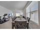 Bright dining room with table and chairs, view into living room and backyard at 1516 Quinta Rd, Kissimmee, FL 34744