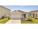 Newly built home with a two-car garage and well-manicured lawn at 1516 Quinta Rd, Kissimmee, FL 34744