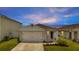 One-story home with a two-car garage and landscaped front yard at 1516 Quinta Rd, Kissimmee, FL 34744