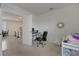 Home office with desk and chair, view into kitchen and dining area at 1516 Quinta Rd, Kissimmee, FL 34744