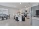 Modern kitchen with gray cabinets, island with seating, and stainless steel appliances at 1516 Quinta Rd, Kissimmee, FL 34744