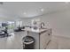 Modern kitchen with stainless steel appliances and island, open to Gathering room at 1516 Quinta Rd, Kissimmee, FL 34744