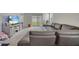 Living room with sectional sofa, TV stand, and access to backyard at 1516 Quinta Rd, Kissimmee, FL 34744