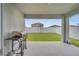 Covered patio with built-in grill and backyard view at 1516 Quinta Rd, Kissimmee, FL 34744