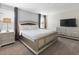 Spacious bedroom with large bed, nightstands, and TV at 1560 Flange Dr, Davenport, FL 33896