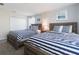 Bedroom with two twin-size beds with blue and white bedding at 1560 Flange Dr, Davenport, FL 33896