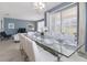 Elegant dining room with a large glass table and white chairs at 1560 Flange Dr, Davenport, FL 33896