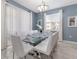 Dining room with glass top table and white chairs at 1560 Flange Dr, Davenport, FL 33896