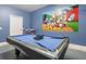 Game room with pool table and Mickey Mouse mural at 1560 Flange Dr, Davenport, FL 33896