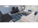 Living room with sectional sofa, coffee table, and blue rug at 1560 Flange Dr, Davenport, FL 33896