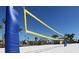 Outdoor sand volleyball court with a net and surrounding palm trees at 1560 Flange Dr, Davenport, FL 33896