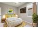 Cozy bedroom with a full-size bed and yellow accents at 217 Montoro Ln, Davenport, FL 33837