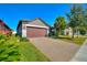 House exterior with a two-car garage and landscaped yard at 217 Montoro Ln, Davenport, FL 33837