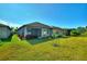 Back of house with a large yard and screened patio at 217 Montoro Ln, Davenport, FL 33837