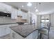 Modern kitchen with granite countertops and white cabinets at 217 Montoro Ln, Davenport, FL 33837