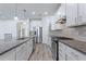 Modern kitchen with stainless steel appliances and granite countertops at 217 Montoro Ln, Davenport, FL 33837