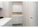Laundry room with utility sink and white cabinets at 217 Montoro Ln, Davenport, FL 33837