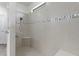 Large walk-in shower with built-in seat and neutral tile at 217 Montoro Ln, Davenport, FL 33837