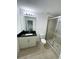 Bathroom with dark vanity, a toilet and a large glass shower at 2614 Old Kent Cir, Kissimmee, FL 34758
