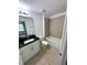 Bathroom with tub, toilet and dark granite vanity at 2614 Old Kent Cir, Kissimmee, FL 34758