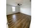 Spacious bedroom with wood-look flooring and a ceiling fan at 2614 Old Kent Cir, Kissimmee, FL 34758