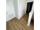 Bright hallway with wood-look flooring and access to bedrooms at 2614 Old Kent Cir, Kissimmee, FL 34758
