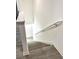 Modern staircase with gray wood-look flooring and white railing at 2614 Old Kent Cir, Kissimmee, FL 34758