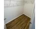 Spacious walk-in closet with wire shelving and wood-look flooring at 2614 Old Kent Cir, Kissimmee, FL 34758