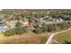 Birds eye view of a home with an orange roof in a neighborhood surrounded by trees and a golf course at 26622 Bull Run, Leesburg, FL 34748