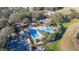 Aerial view of community amenities including swimming pools, clubhouse, and surrounding landscape, highlighting a vibrant community at 26622 Bull Run, Leesburg, FL 34748
