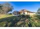A home with a screen lanai, green lawn, and tasteful landscaping at 26622 Bull Run, Leesburg, FL 34748
