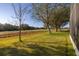 Lawn view of the backyard next to the golf course with mature trees and lots of light at 26622 Bull Run, Leesburg, FL 34748